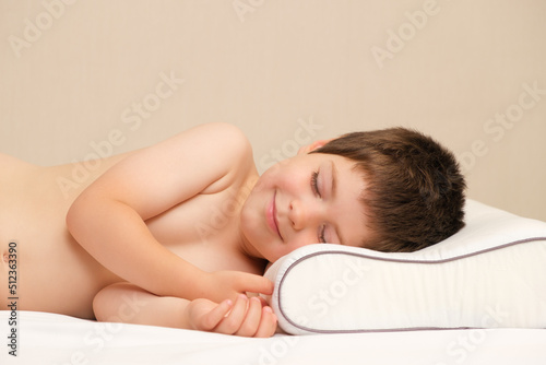 A 5-year-old boy lies on a children s orthopedic pillow made of memory foam