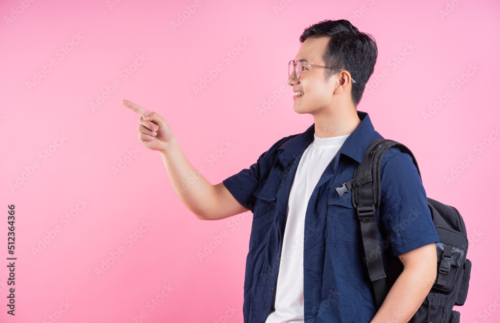 Image of young Asian college student on pink background Image of young Asian college student on pink background