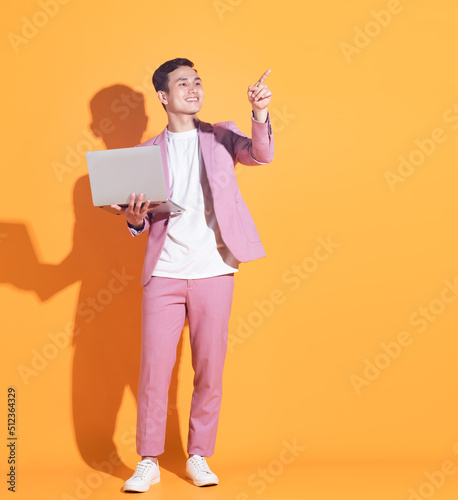 Portrait of young Asian man posing on background