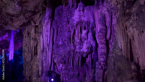 Massive stalactites in St. Michael's cave lit by purple light, Gibraltar.