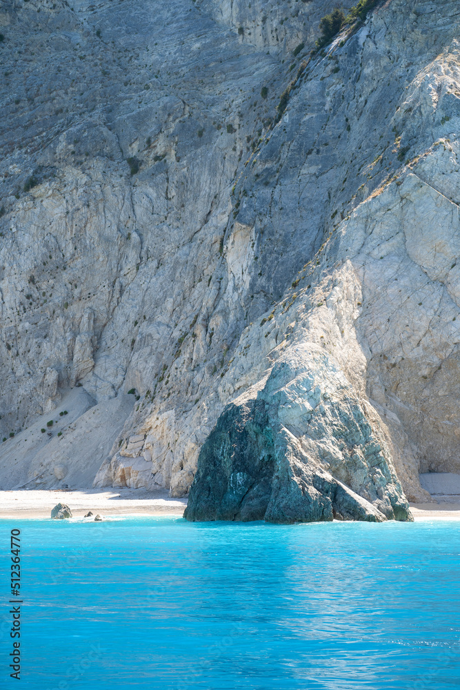 Beautiful wild Mediterranean pebble beach under a large massive rock Beautiful wild Mediterranean pebble beach under a large massive rock