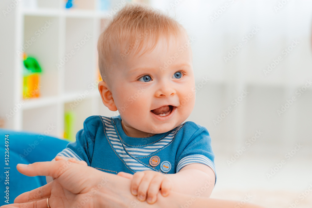 Baby taking first steps with mother's help at home Baby taking first steps with mother's help at home