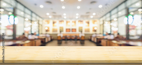 Empty wood table top with cafe restaurant interior blurred background