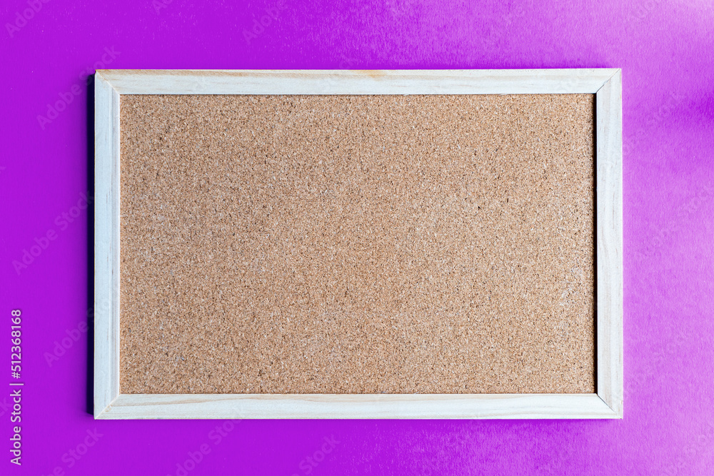 Fototapeta premium A cork board is a framed section of cork backed with wood or plastic. Typically, it is used as a bulletin board, because the resilient nature of cork makes it ideal for sticking pins and tacks into.