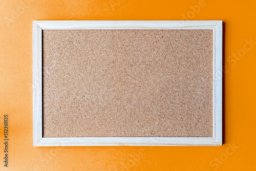 Fotobehang A cork board is a framed section of cork backed with wood or plastic