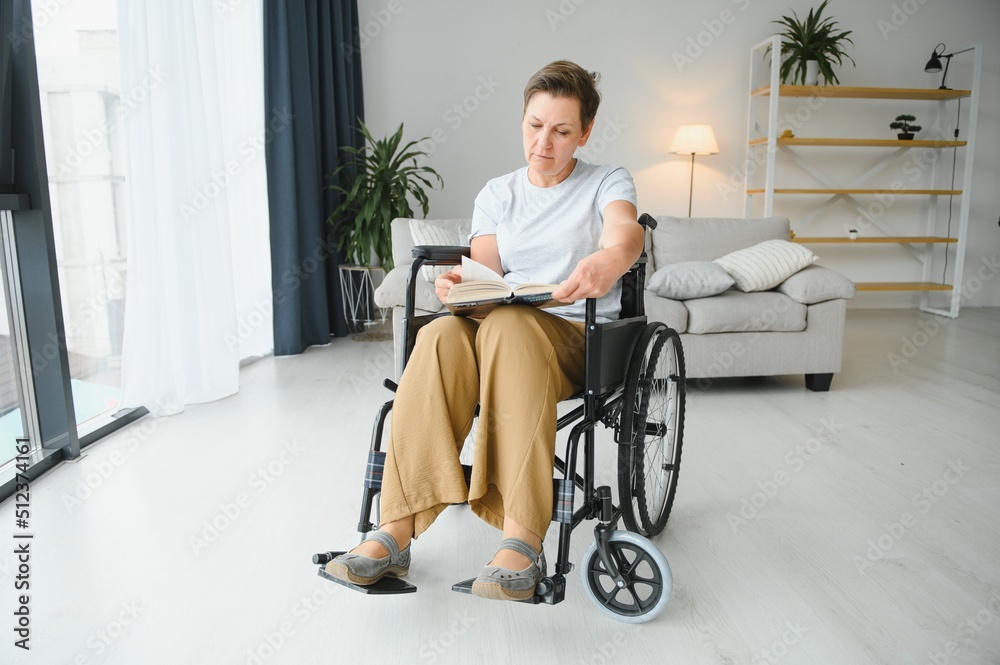 middle aged woman sitting on wheelchair middle aged woman sitting on wheelchair