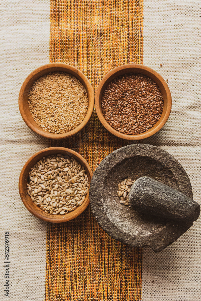 kind of raw seed in a wooden bowl kind of raw seed in a wooden bowl