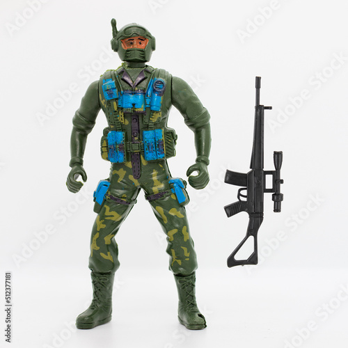 plastic green soldier with black ak47 rifle gun wearing bulletproof camouflage war clothes, hanging tactical accessories