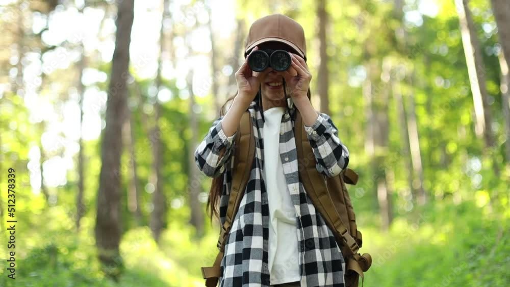 Girl looking through binoculars in park
Girl looking through binoculars in park