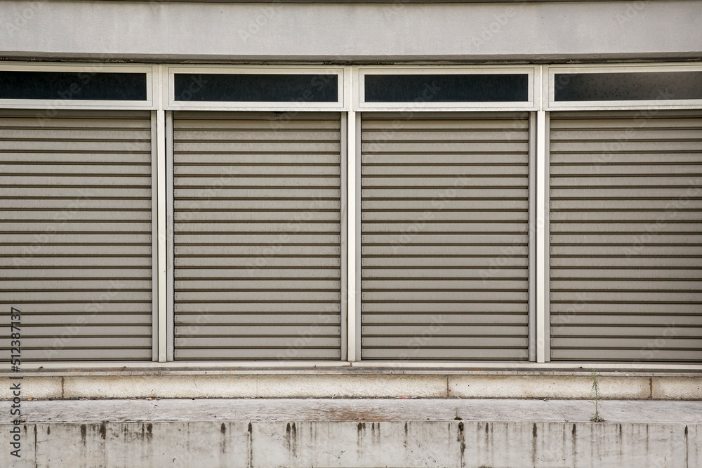 Four windows with closed shutters. Four windows with closed shutters.