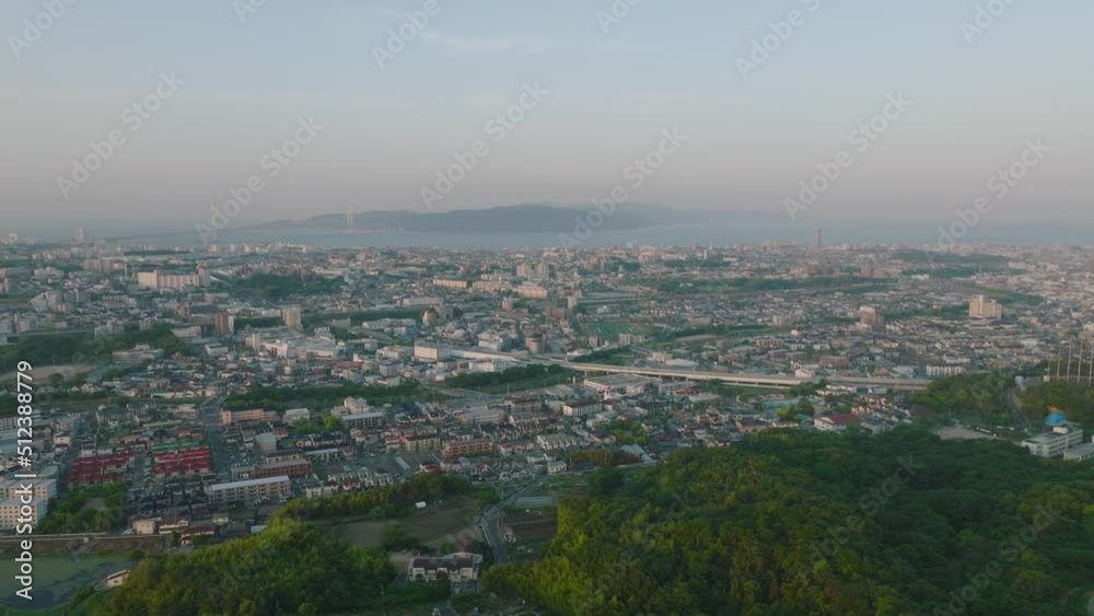 Aerial move along sprawling coastal city after sunrise Aerial move along sprawling coastal city after sunrise