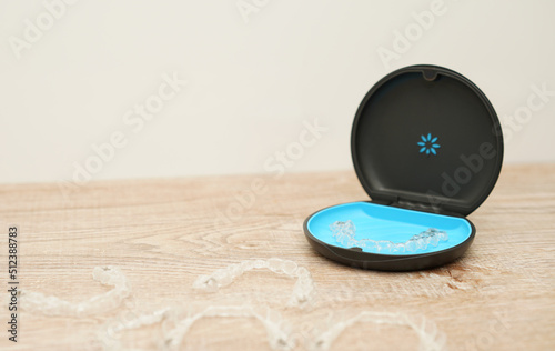 invisalign is invisible transparent aligners , clear-plastic retainers in blue box. With copyspace