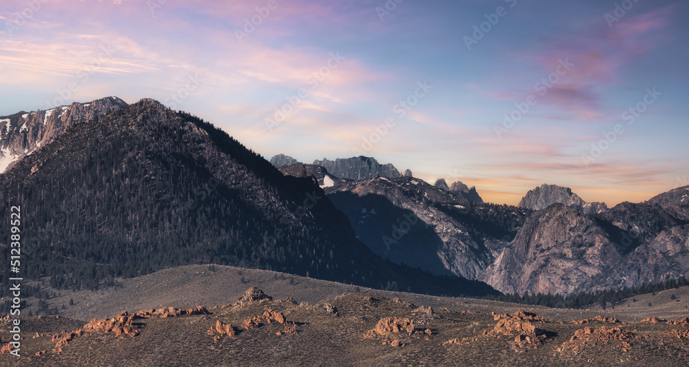 Dry rocky desert mountain landscape with trees. Colorful Cloudy Sunrise Art Render. California, United States of America. Nature Background.