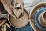 Pottery Master Holding a Heart Crafted from Clay, Handmade Work