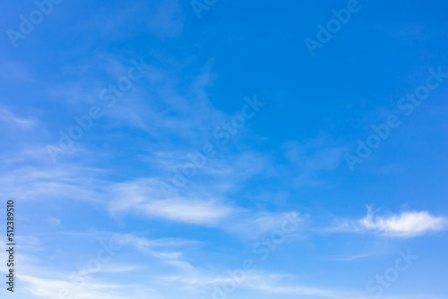 Light and soft clouds floating over the blue sky. Nice weather in the summer atmosphere vast outdoor scene, abstract and freedom bright cloudscape. Tranquil and calm nature. Natural background.
