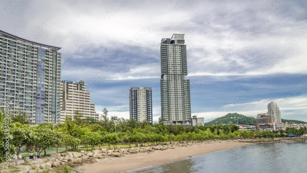 Time lapse of the beach front near Koh Loy island in Sri Racha, Chon Buri, Thailand shows moving clouds and high rise hotel buildings Time lapse of the beach front near Koh Loy island in Sri Racha, Chon Buri, Thailand shows moving clouds and high rise hotel buildings