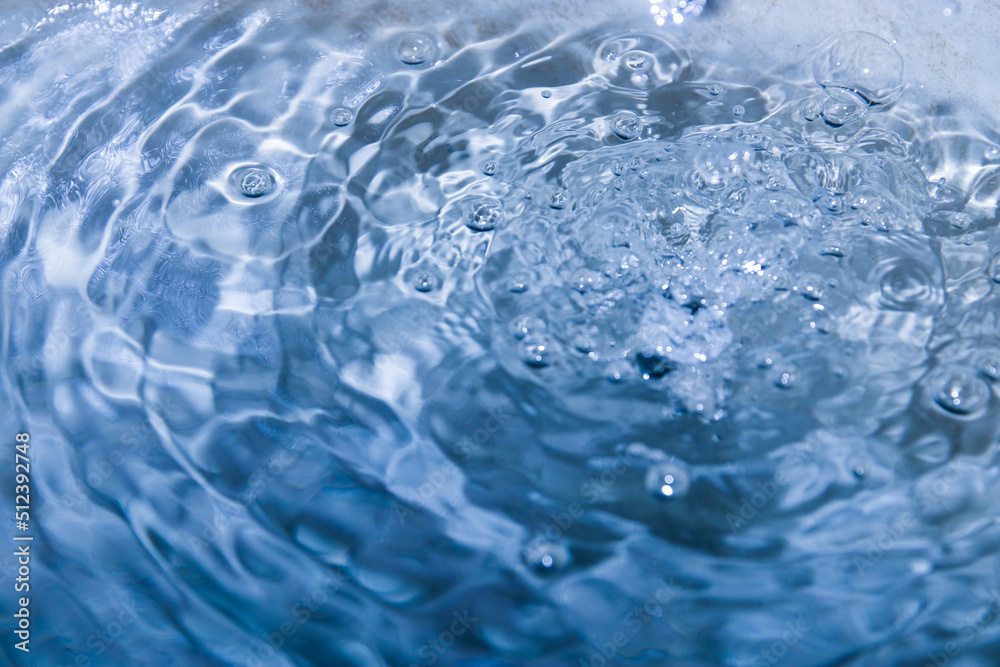 The turquoise water had water droplets falling from above causing ripples. The turquoise water had water droplets falling from above causing ripples.