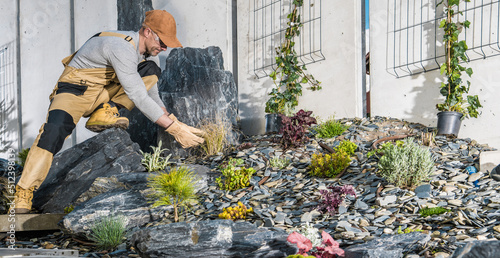 Caucasian Professional Landscaping Gardener in His 40s Finishing New Residential Garden photo