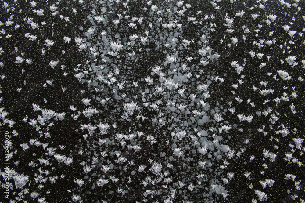 Texture of frozen ice surface with snow. Winter background