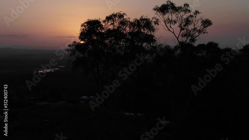 Drone pov through trees of Noosa Heads at dusk from mount Tinbeerwah in Queensland, Australia photo