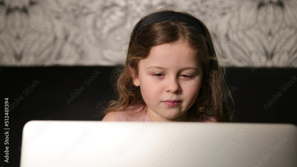 Portrait young girl holding laptop. Lass using computer at home. Adorable six year old 6 miss sitting with notebook. Close-up Portrait young girl holding laptop. Lass using computer at home. Adorable six year old 6 miss sitting with notebook. Close-up