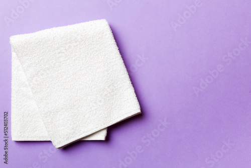 Top view of white towels with copy space on colored background © sosiukin