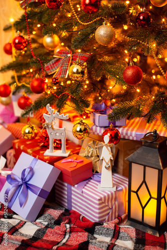 Beautiful composition of presents  toys beneath decorated Christmas tree. Festive Christmas background