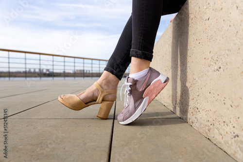 Woman in shoes and sneakers. Woman choosing comfortable sneakers