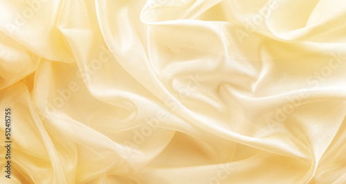 shiny golden fabric draped with folds, textile wave background