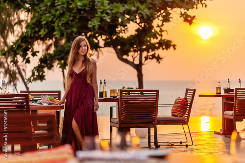 Fotografiet Elegant attractive smiling woman on romantic dinner in luxury gourmet restaurant