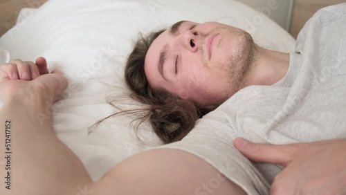 Young handsome man sleeping on bed photo