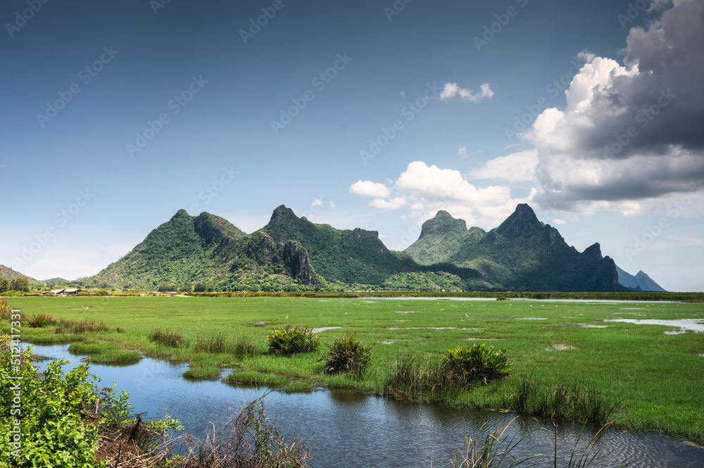 Green mountain range of Khao Sam Roi Yot on wetland and blue sky in national park at Prachuap Khiri Khan Green mountain range of Khao Sam Roi Yot on wetland and blue sky in national park at Prachuap Khiri Khan