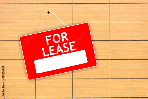 FOR LEASE red sign with white word and empty space hanged on wooden background advertising template.