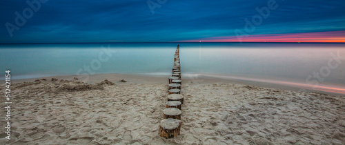 Obraz na płótnie Amazing sunrise over the beach in Chalupy. Seascape with breakwater w salonie
