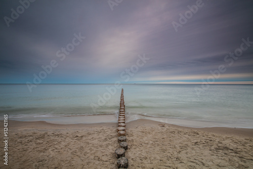 Obraz na płótnie Amazing sunrise over the beach in Chalupy. Seascape with breakwater w salonie