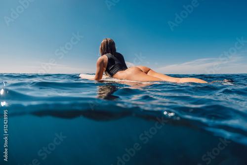 Photography Beautiful surfing girl in sexy bikini with surfboard