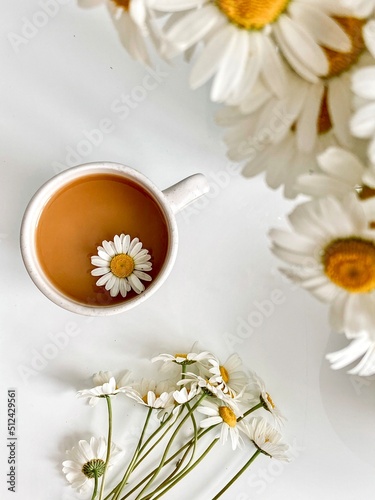 cup of coffee with chamomile flat lay