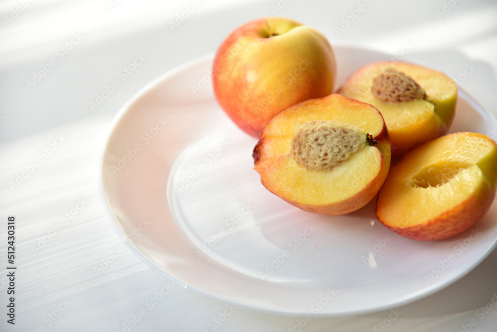 Sliced peaches and nectarines on a white plate