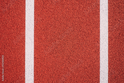 Colorful sports court background. Top view to red field rubber ground with white lines outdoors © vejaa
