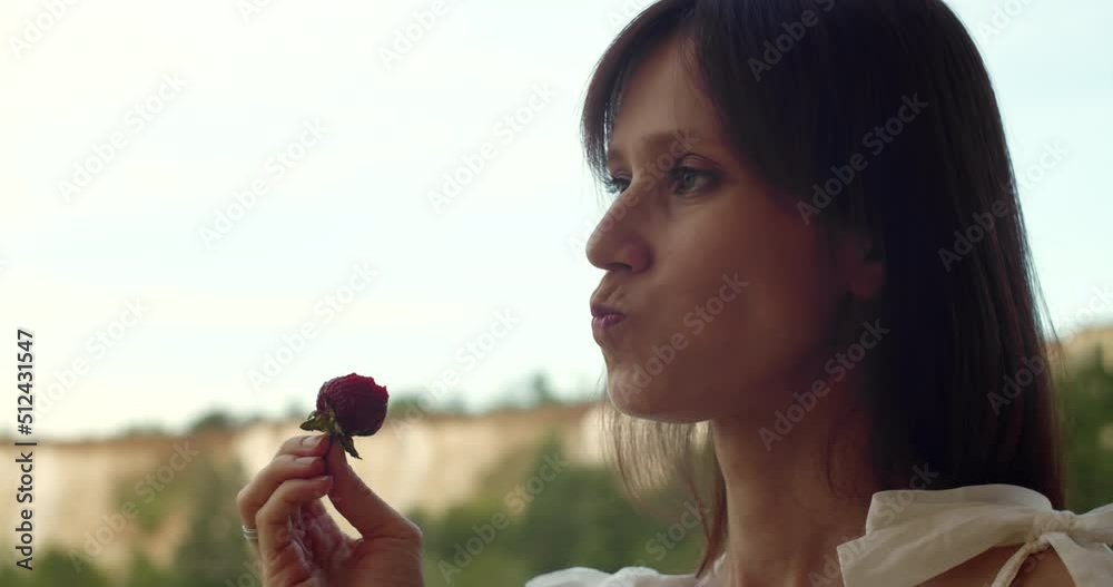 Woman enjoy eat of strawberry on terrace of house on nature, recreation and digital detox