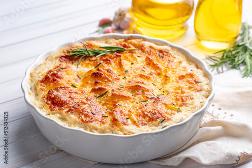 Potato gratin - graten (baked potatoes with cream and cheese) with rosemary and forks (Turkish name; Kremali patates) photo