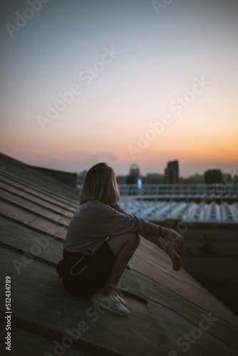 Young woman posing in the roof at sunset, freedom city atmosphere. People, lifestyle, relaxation concept. © maxbelchenko