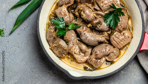 Stewed chicken stomach, Traditional Korean spicy chicken gizzard with onions, garlic, chili and sesame on a dark background, place for text, top view photo