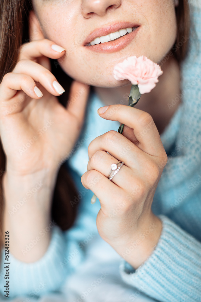 Crop photo of woman with beautiful toothy smile, white teeth, Smiling young woman with flower. Unrecognizable people Crop photo of woman with beautiful toothy smile, white teeth, Smiling young woman with flower. Unrecognizable people