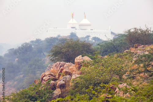 view of govardhan hill rocky surface where vegetation is around vrindavan india