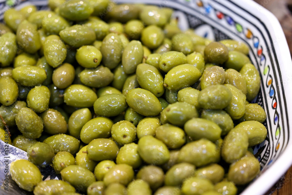 green olives in an old ceramic bowl green olives in an old ceramic bowl