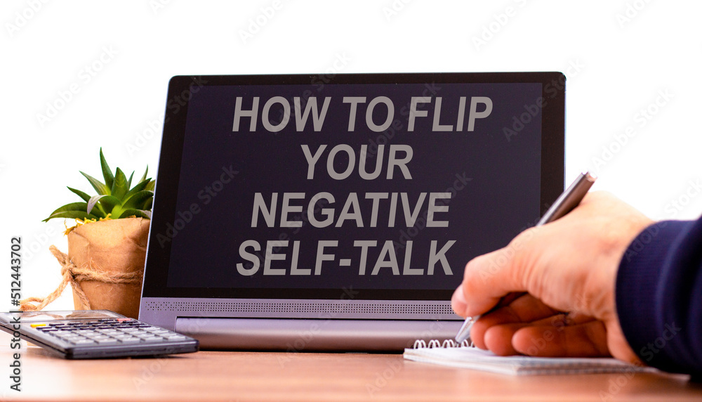 Flip negative self-talk symbol. Concept words How to flip your negative self-talk on the black tablet. Businessman hand with pen. Psychological flip negative self-talk concept. Copy space. Flip negative self-talk symbol. Concept words How to flip your negative self-talk on the black tablet. Businessman hand with pen. Psychological flip negative self-talk concept. Copy space.