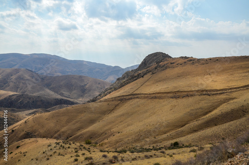 View of hilly relief, mountain slopes with sparse vegetation of autumn Caucasus mountains in Armenia