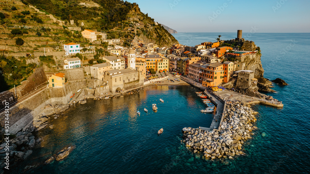 Aerial view of Vernazza and coastline of Cinque Terre,Italy.UNESCO Heritage Site.Picturesque colorful village on rock above sea.Summer holiday,travel background.Italian Riviera landscape.Steep cliff