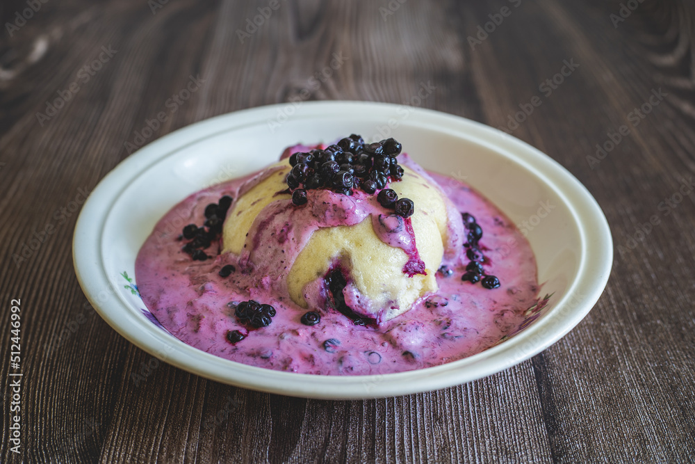 Homemade blueberry dumplings with cream,Czech sweet dessert typical in the mountains.Fresh blueberries. Sweet fruit dumplings.Czech cuisine.Food in ceramic vintage bowl on wooden table Homemade blueberry dumplings with cream,Czech sweet dessert typical in the mountains.Fresh blueberries. Sweet fruit dumplings.Czech cuisine.Food in ceramic vintage bowl on wooden table